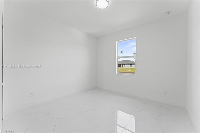 empty room with baseboards
