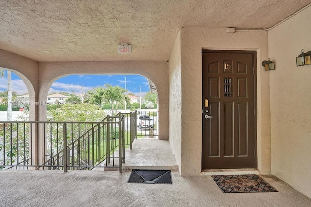 doorway to property featuring stucco siding