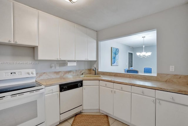 kitchen with light tile patterned flooring, light countertops, a sink, white appliances, and white cabinets