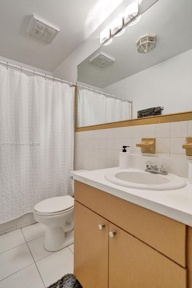 full bath featuring vanity, tile walls, toilet, tile patterned floors, and visible vents