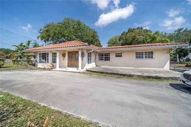 85 NW 165th St, Miami, FL 33169 - mediterranean / spanish house with a tile roof, stucco siding, and aphalt driveway