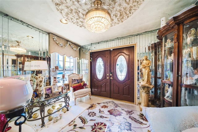 85 NW 165th St, Miami, FL 33169 - foyer with french doors, tile patterned floors, and a chandelier