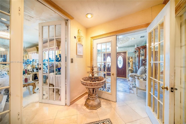 85 NW 165th St, Miami, FL 33169 - entryway featuring a textured wall, french doors, tile patterned flooring, and plenty of natural light