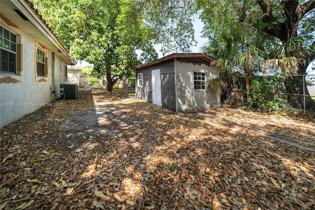 85 NW 165th St, Miami, FL 33169 - view of yard featuring an outdoor structure, central AC, and fence