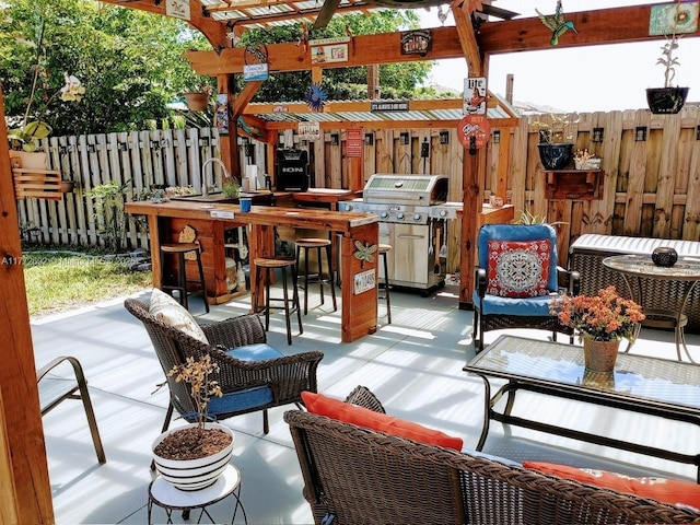 view of patio with grilling area and fence