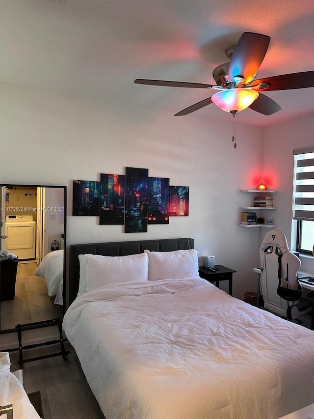 bedroom with a ceiling fan, washer / clothes dryer, and wood finished floors