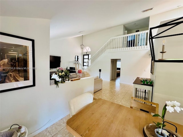 11774 SW 92nd Ter, Miami, FL 33186 - dining area with tile patterned floors, stairs, baseboards, and high vaulted ceiling