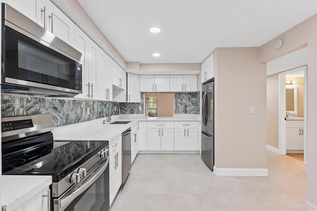 6563 Racquet Club Dr Unit 124, Lauderhill, FL 33319 - kitchen with stainless steel appliances, backsplash, white cabinets, and recessed lighting