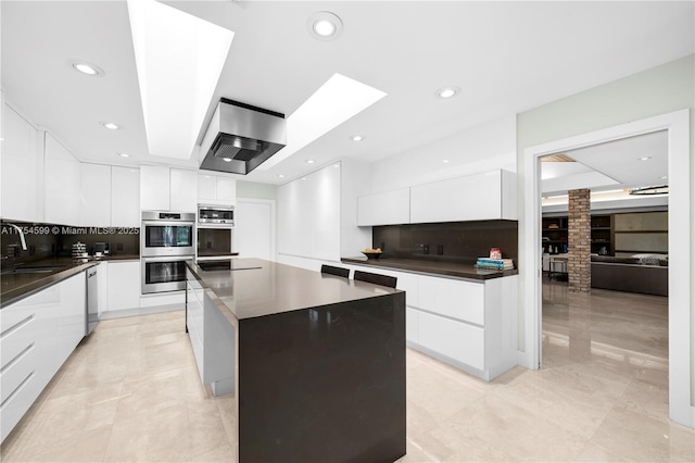 9000 Arvida Dr, Coral Gables, FL 33156 - kitchen with modern cabinets, stainless steel appliances, and custom range hood