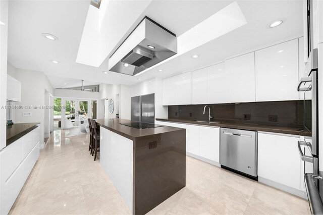 9000 Arvida Dr, Coral Gables, FL 33156 - kitchen featuring modern cabinets, dark countertops, white cabinetry, a sink, and stainless steel dishwasher