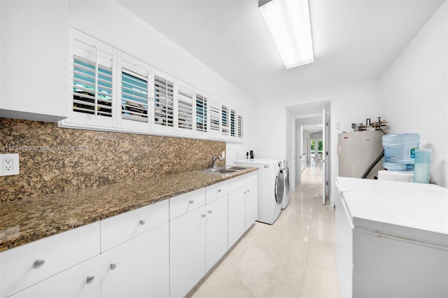 9000 Arvida Dr, Coral Gables, FL 33156 - washroom with water heater, washer and clothes dryer, and a sink