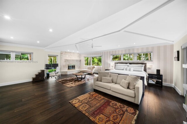 9000 Arvida Dr, Coral Gables, FL 33156 - bedroom with dark wood-style flooring, crown molding, baseboards, a stone fireplace, and lofted ceiling