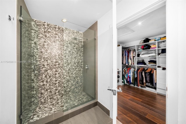 9000 Arvida Dr, Coral Gables, FL 33156 - bathroom with wood finished floors, a stall shower, and a walk in closet