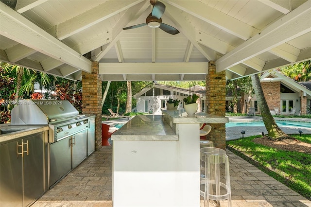 9000 Arvida Dr, Coral Gables, FL 33156 - view of patio with a ceiling fan, an outdoor pool, a grill, exterior kitchen, and outdoor wet bar
