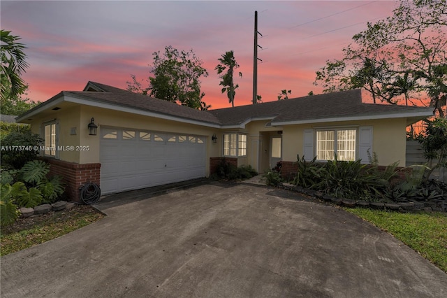 13878 SW 151st Ln, Miami, FL 33186 - ranch-style house with brick siding, driveway, a garage, and stucco siding
