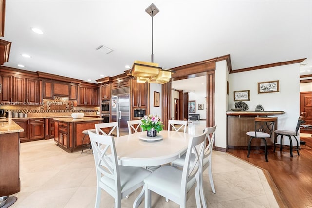 dining area featuring ornamental molding, recessed lighting, and visible vents