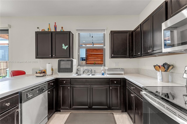 kitchen featuring light countertops, a sink, and appliances with stainless steel finishes