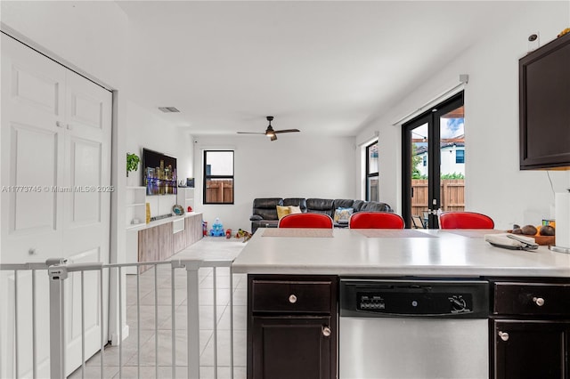 kitchen with open floor plan, light countertops, ceiling fan, dishwasher, and a peninsula
