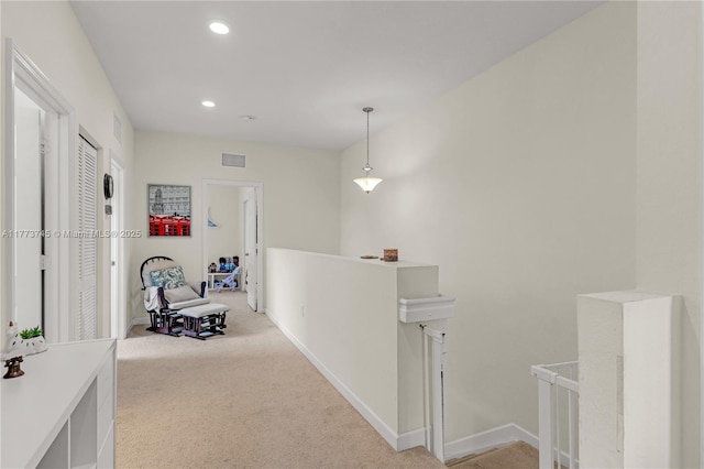 hallway featuring recessed lighting, an upstairs landing, light carpet, and visible vents