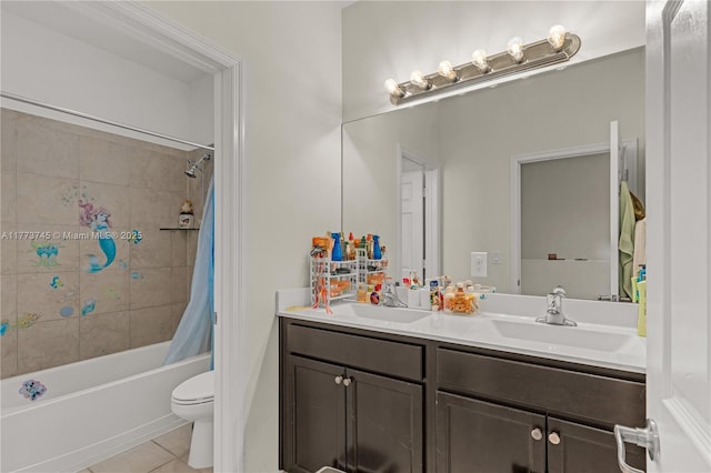 bathroom featuring tile patterned flooring, a sink, toilet, and shower / bath combo with shower curtain