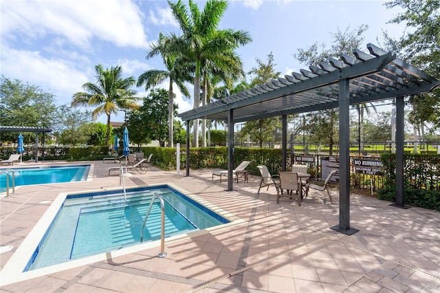 community pool with a pergola, fence, and a patio