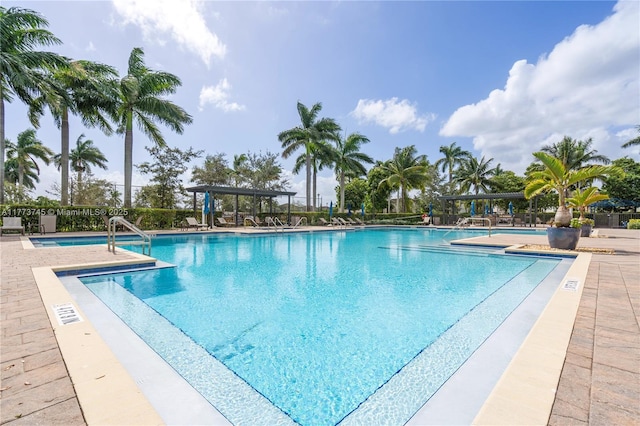 community pool featuring a pergola, fence, and a patio area