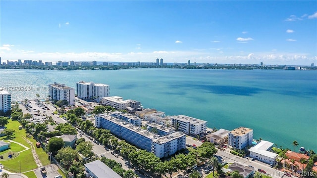 birds eye view of property with a view of city and a water view