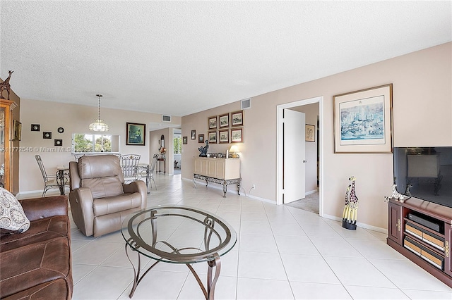 12750 SW 4th Ct Unit 407J, Pembroke Pines, FL 33027 - living room with a textured ceiling and light tile patterned floors