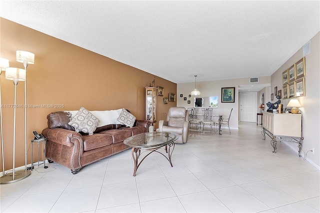 12750 SW 4th Ct Unit 407J, Pembroke Pines, FL 33027 - living area featuring a textured ceiling and light tile patterned floors