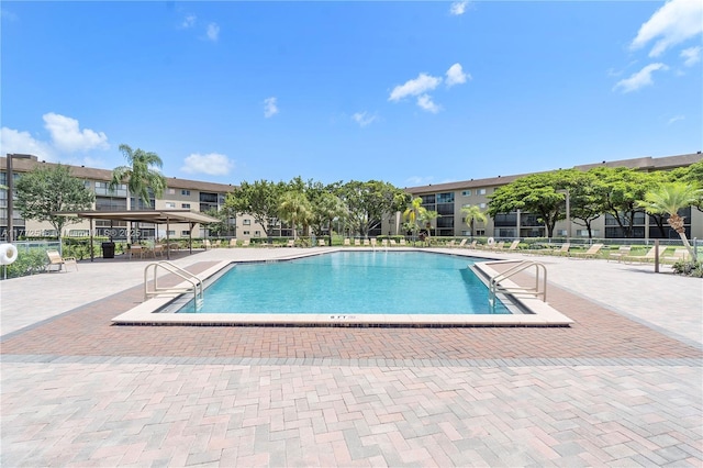 12750 SW 4th Ct Unit 407J, Pembroke Pines, FL 33027 - community pool featuring a patio area