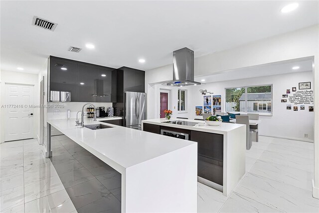 910 N 70th Ave, Hollywood, FL 33024 - kitchen with a sink, freestanding refrigerator, modern cabinets, island range hood, and light marble finish floors