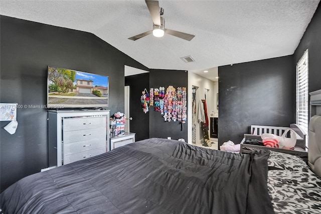 bedroom with visible vents, lofted ceiling, and a textured ceiling