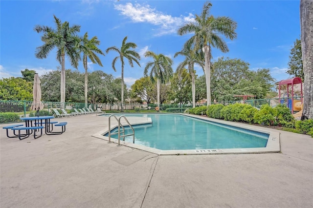 community pool featuring fence and a patio area