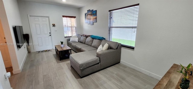 living room with light wood-style flooring and baseboards