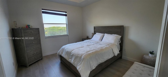 bedroom with baseboards and light wood-type flooring