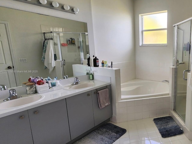bathroom with a stall shower, a bath, and a sink