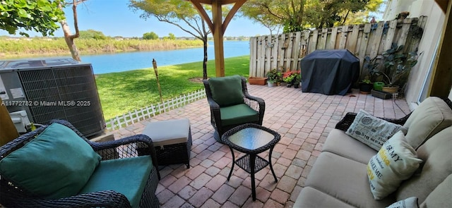 view of patio / terrace featuring central air condition unit, fence, grilling area, a water view, and an outdoor living space