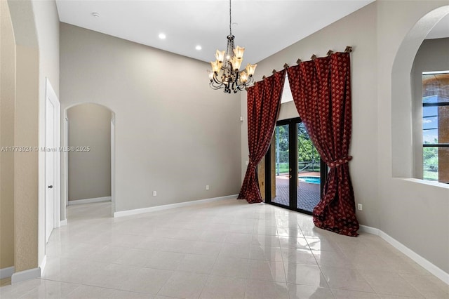 2031 SW 185th Ave, Miramar, FL 33029 - empty room featuring arched walkways, plenty of natural light, a chandelier, recessed lighting, and a high ceiling