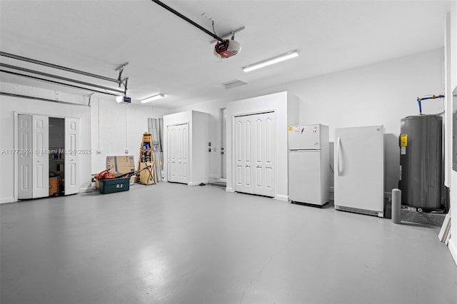 2031 SW 185th Ave, Miramar, FL 33029 - garage featuring freestanding refrigerator, water heater, and a garage door opener