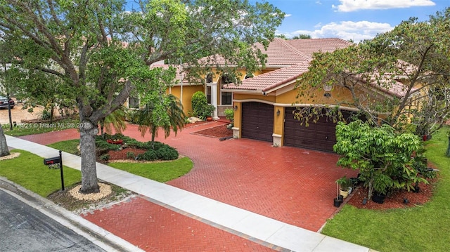 2031 SW 185th Ave, Miramar, FL 33029 - view of front of home featuring a tile roof, a garage, stucco siding, and decorative driveway