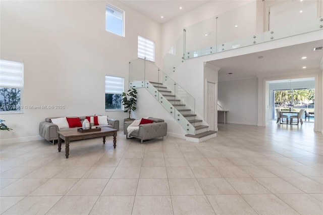 2426 Deer Creek Rd, Weston, FL 33327 - living area with stairs, light tile patterned flooring, a high ceiling, and baseboards