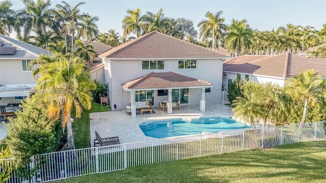 2426 Deer Creek Rd, Weston, FL 33327 - rear view of house with a fenced backyard, stucco siding, a patio area, a lawn, and a tile roof