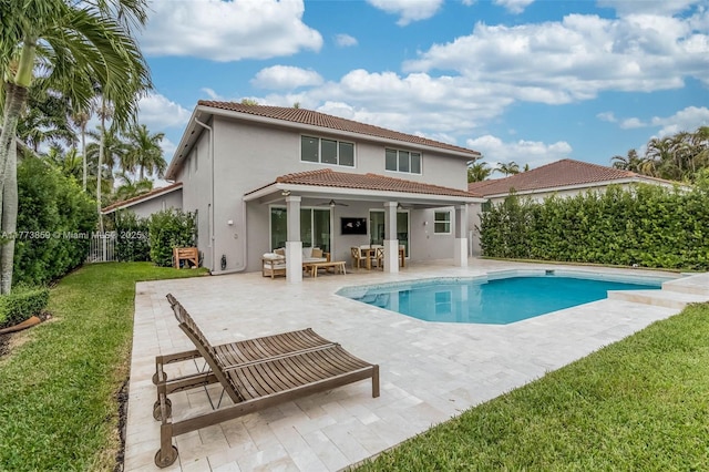 2426 Deer Creek Rd, Weston, FL 33327 - rear view of property featuring a ceiling fan, a lawn, fence private yard, a patio, and stucco siding