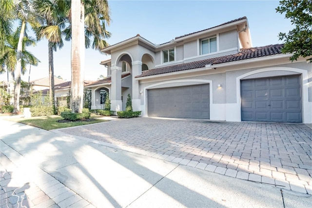 2426 Deer Creek Rd, Weston, FL 33327 - mediterranean / spanish house with stucco siding, a tile roof, and decorative driveway