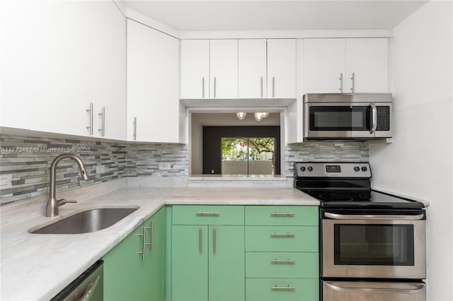 6890 N Kendall Dr Unit B202, Pinecrest, FL 33156 - kitchen featuring stainless steel appliances, white cabinets, and decorative backsplash
