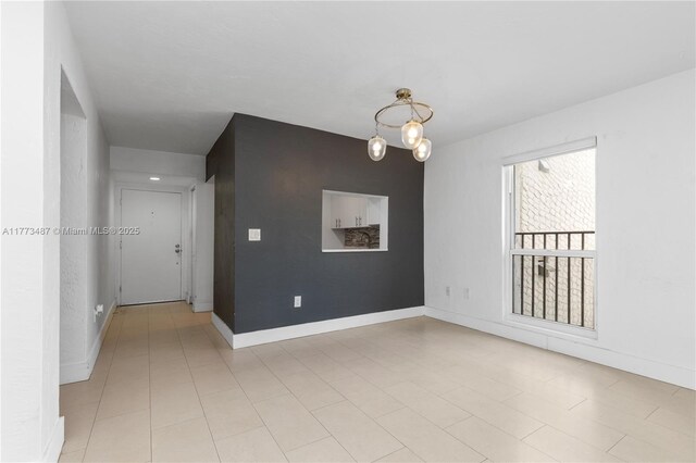 6890 N Kendall Dr Unit B202, Pinecrest, FL 33156 - spare room with a chandelier and baseboards