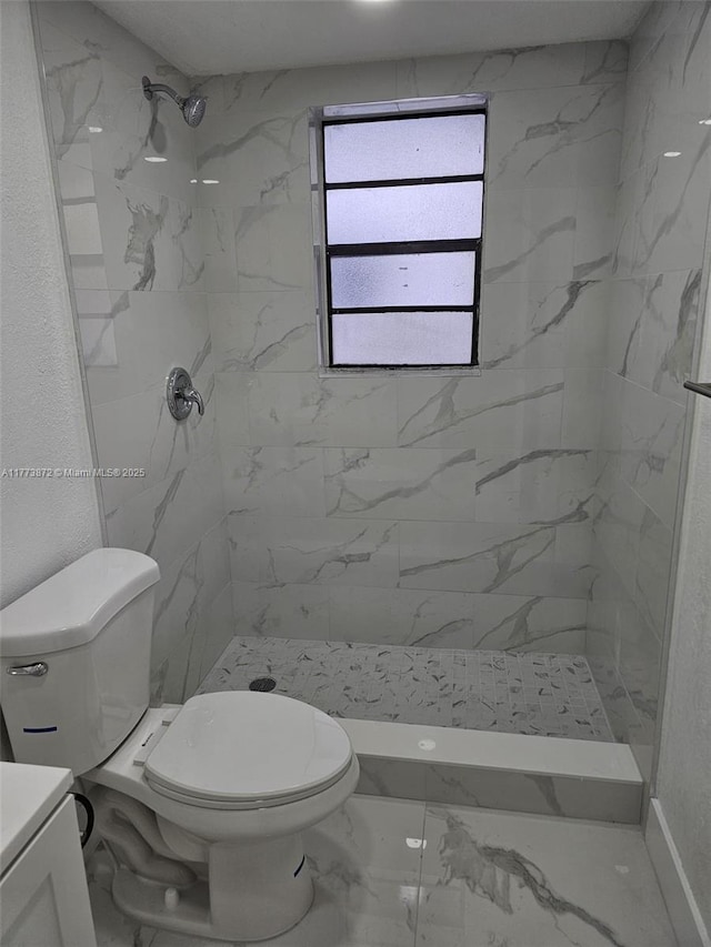 full bath featuring marble finish floor, vanity, a marble finish shower, and toilet