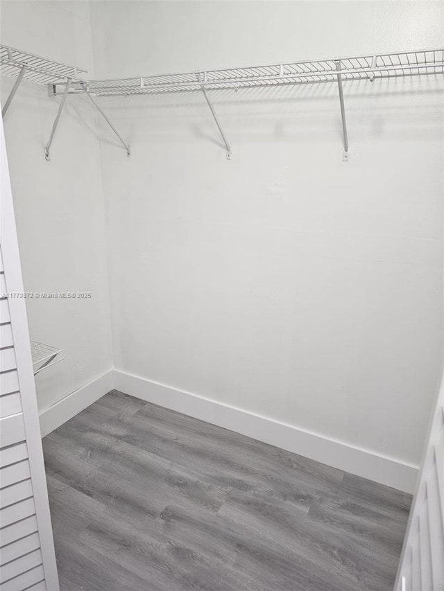 spacious closet with wood finished floors