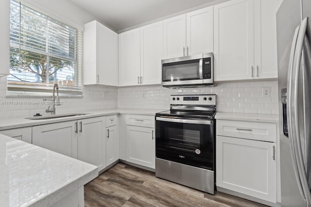 2556 SE 15th Ct, Homestead, FL 33035 - kitchen with a sink, white cabinets, appliances with stainless steel finishes, and dark wood-style floors