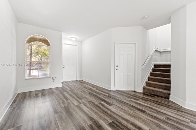 2556 SE 15th Ct, Homestead, FL 33035 - unfurnished room with stairs, baseboards, and dark wood-style flooring
